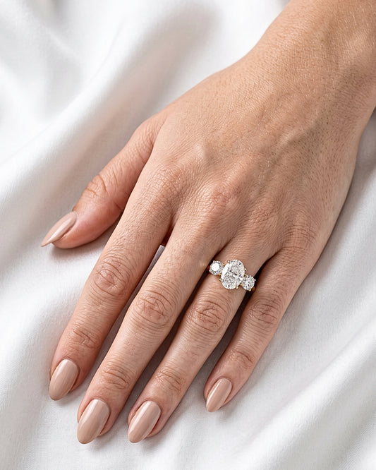 Iris: Oval Trilogy Round Setting Moissanite Engagement Ring