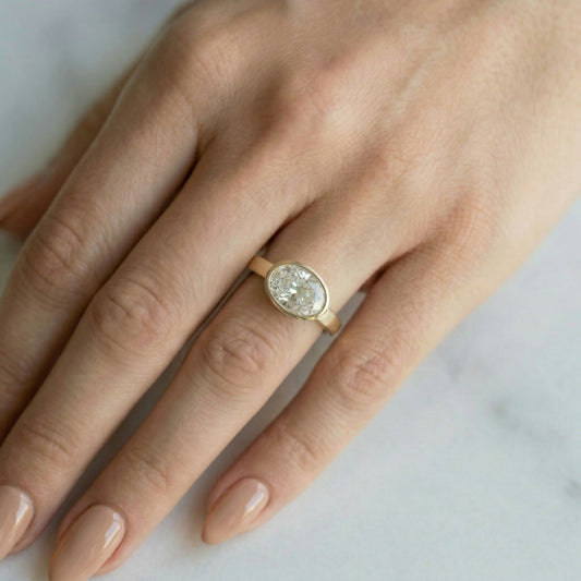 East West Bezel Oval Solitaire Diamond Engagement Ring