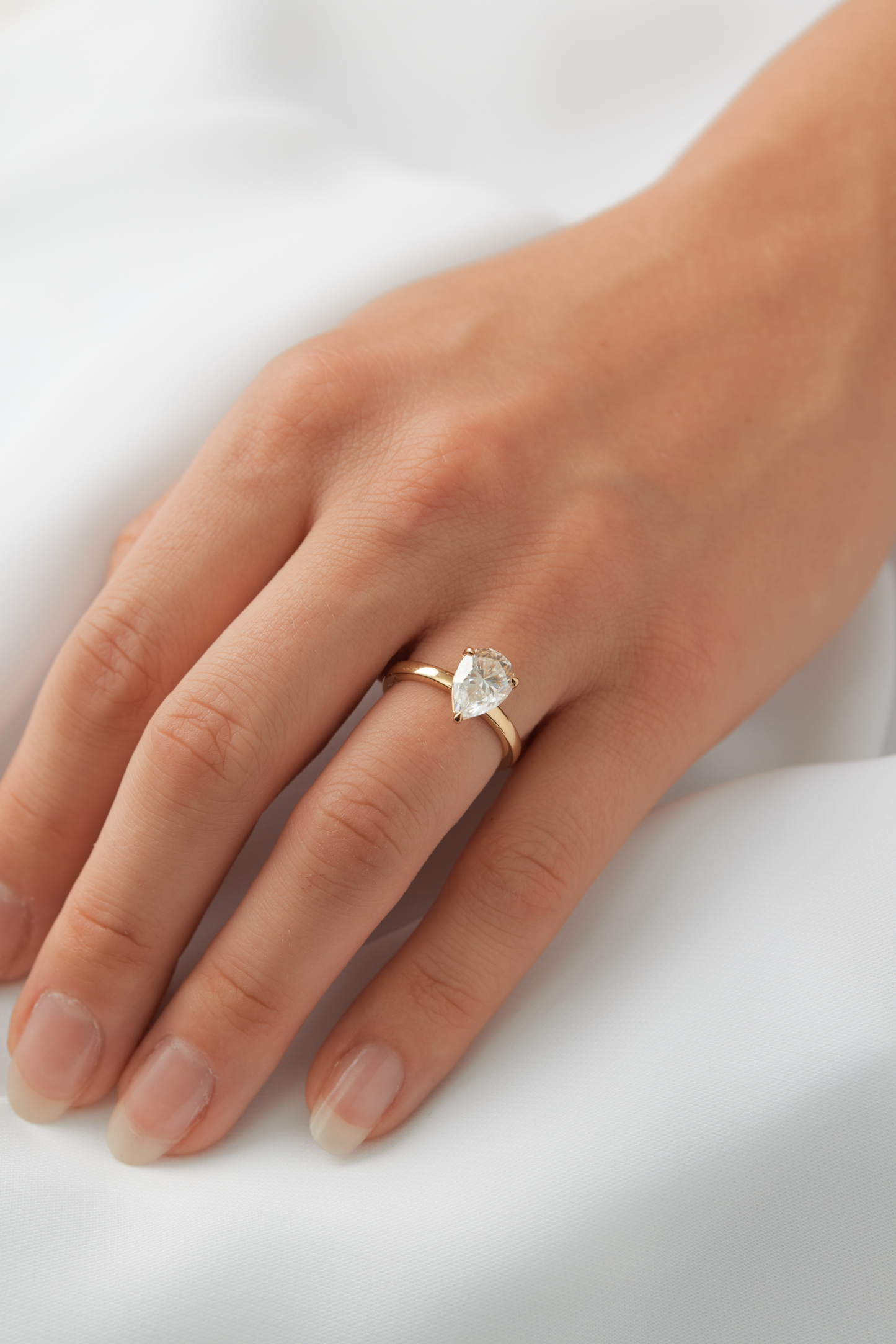 moissanite, pear solitaire, gold band, worn on hand, engagement ring | Moissanite Engagement Rings
