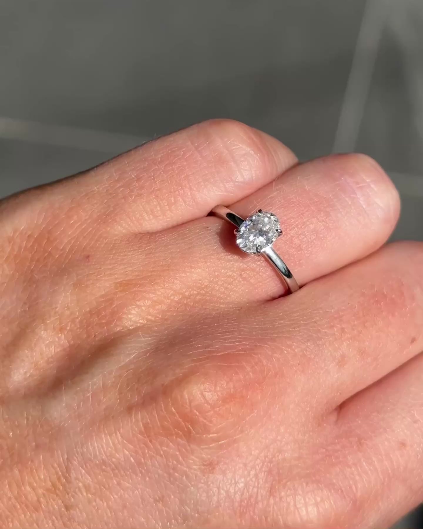 video by moissanite engagement rings, oval solitaire moissanite, elegant design, multiple angles shown, close-up sparkle detail | Moissanite Engagement Rings