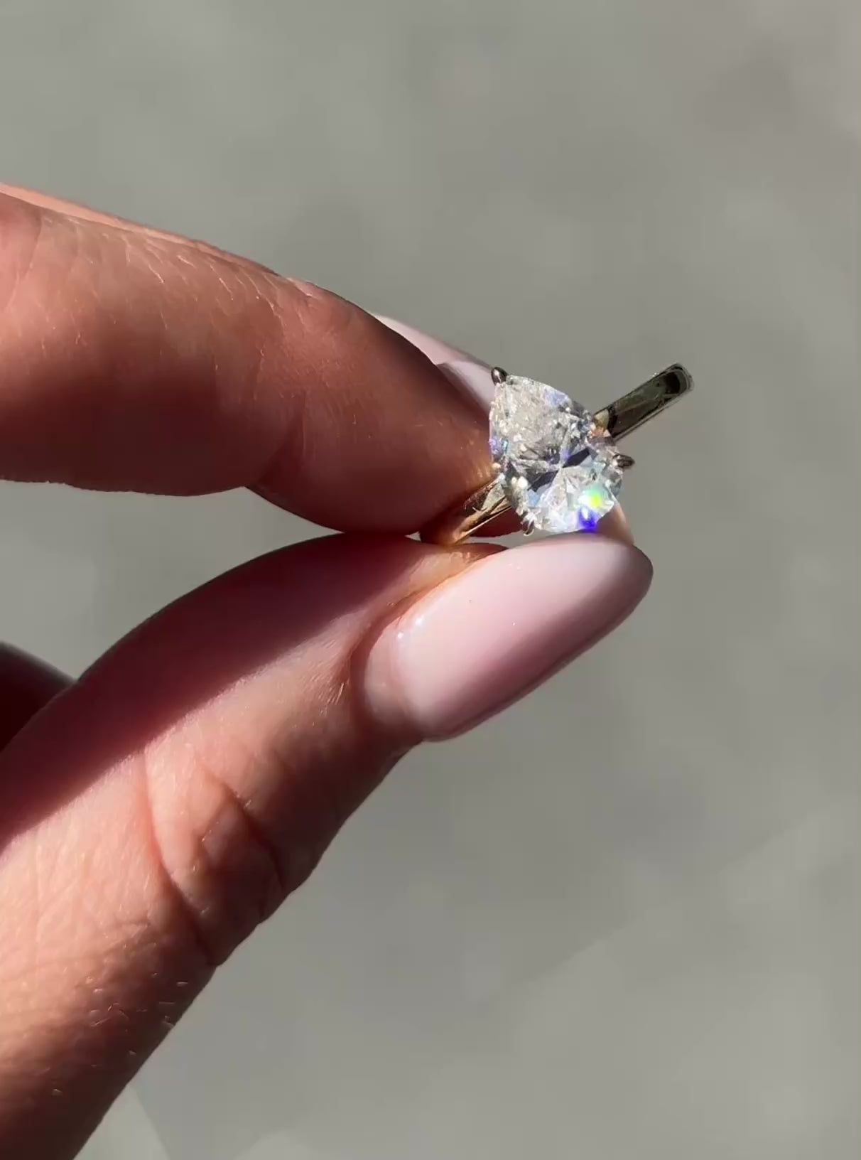 close-up video, pear solitaire moissanite ring, sparkle detail, teardrop shape focus, minimalist setting | Moissanite Engagement Rings