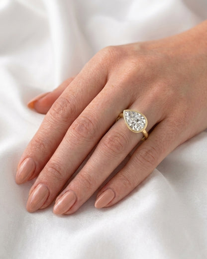 Charlie: East West Bezel Pear Solitaire Moissanite Engagement Ring