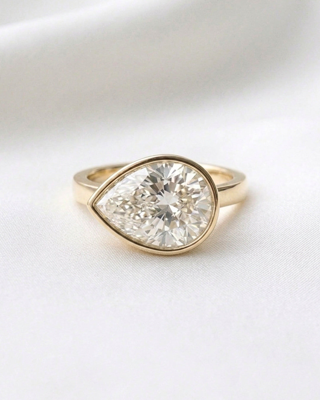 Charlie: East West Bezel Pear Solitaire Moissanite Engagement Ring