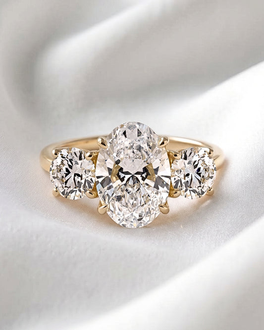 Iris: Oval Trilogy Round Setting Moissanite Engagement Ring