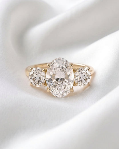 Iris - Oval Trilogy Round Setting Moissanite Engagement Ring