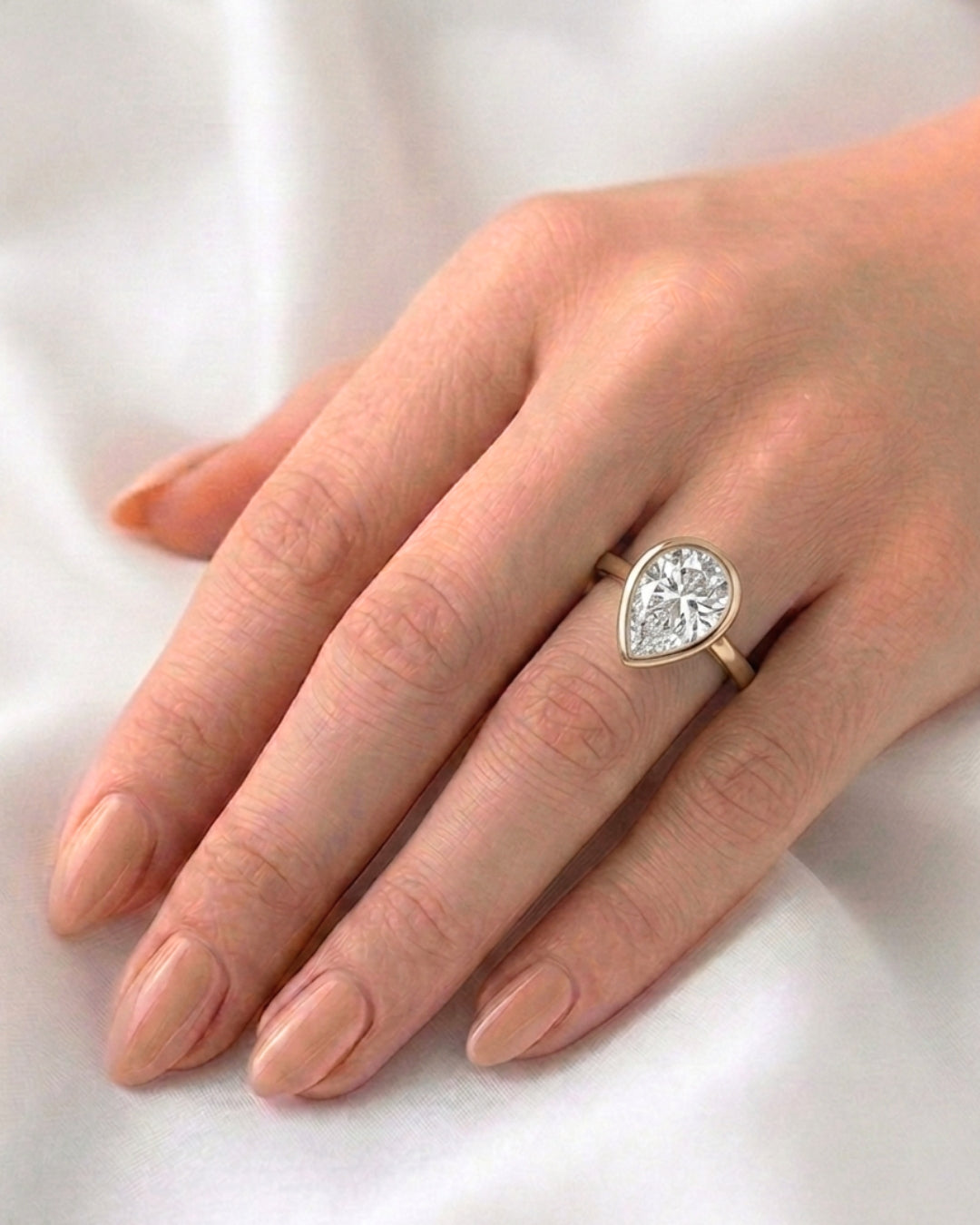 Mae: Pear Bezel Moissanite Engagement Ring