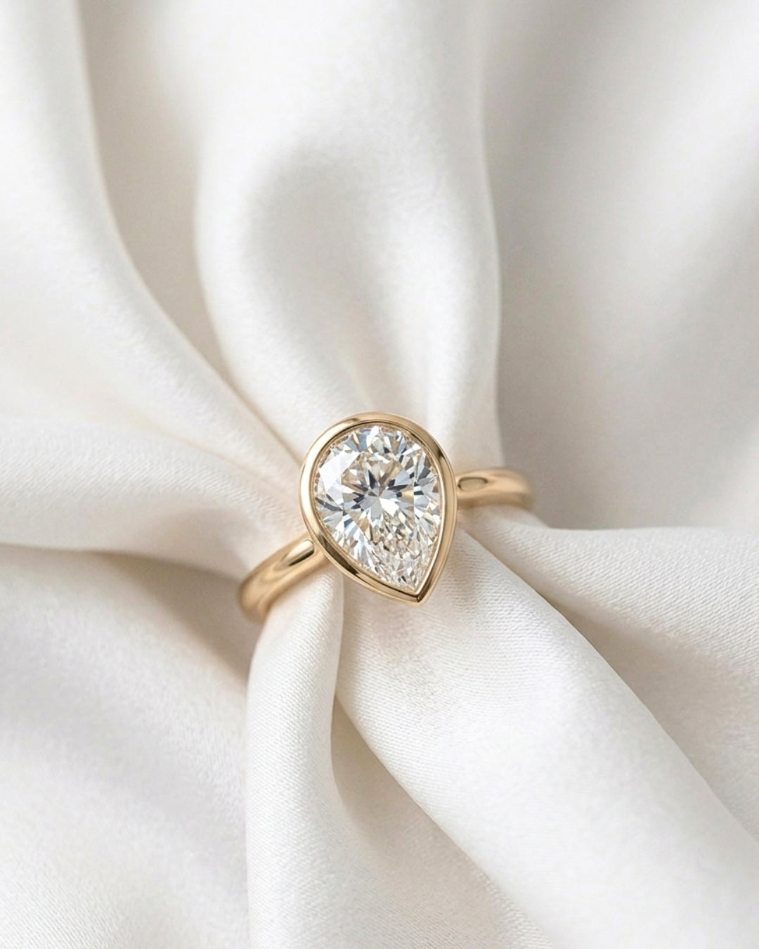 Mae: Pear Bezel Moissanite Engagement Ring