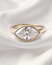 Pearl: East West Bezel Marquise Solitaire Moissanite Engagement Ring