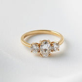 Iris: Oval Trilogy Round Setting Moissanite Engagement Ring