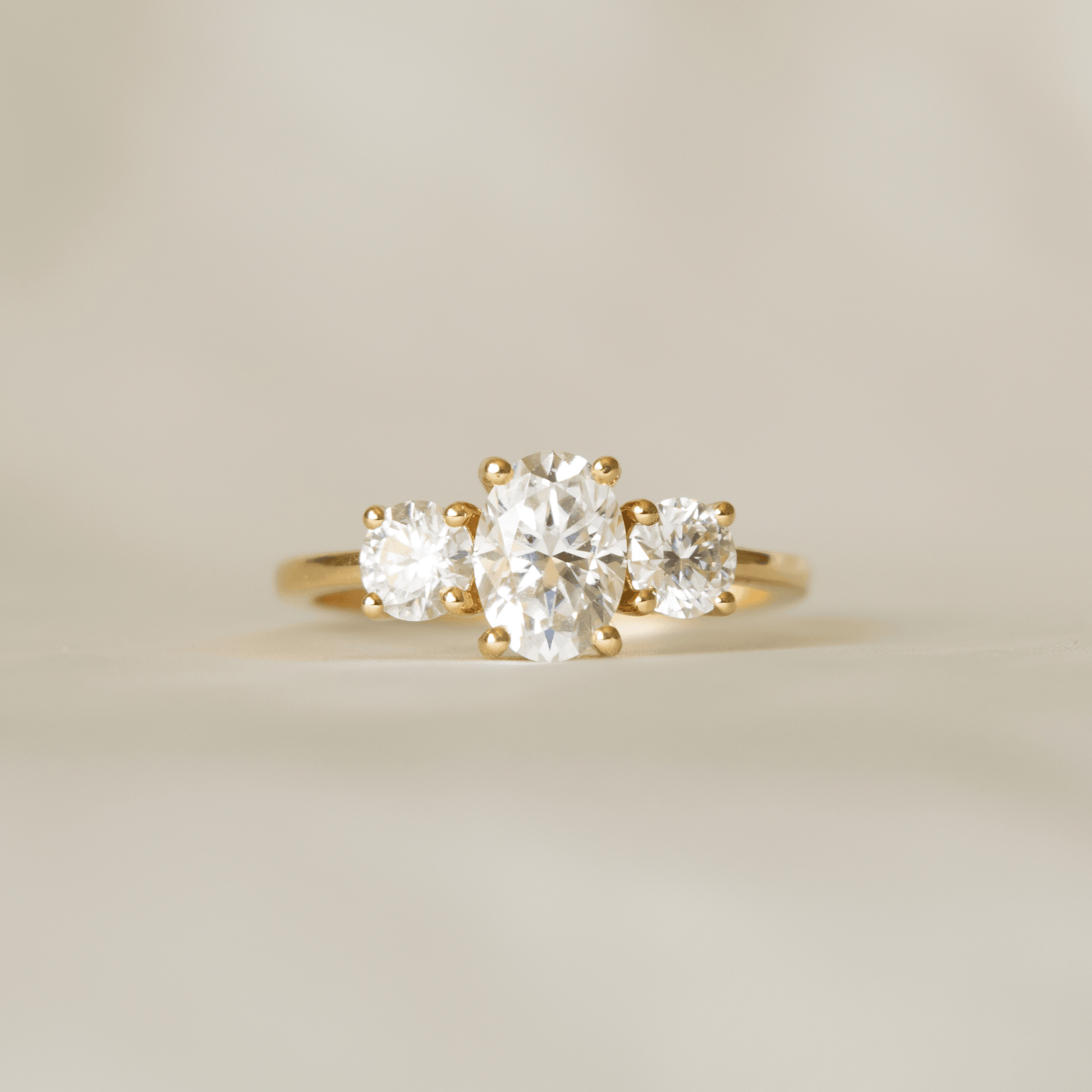 Oval Trilogy Round Setting Moissanite Engagement Ring - moissaniteengagementrings