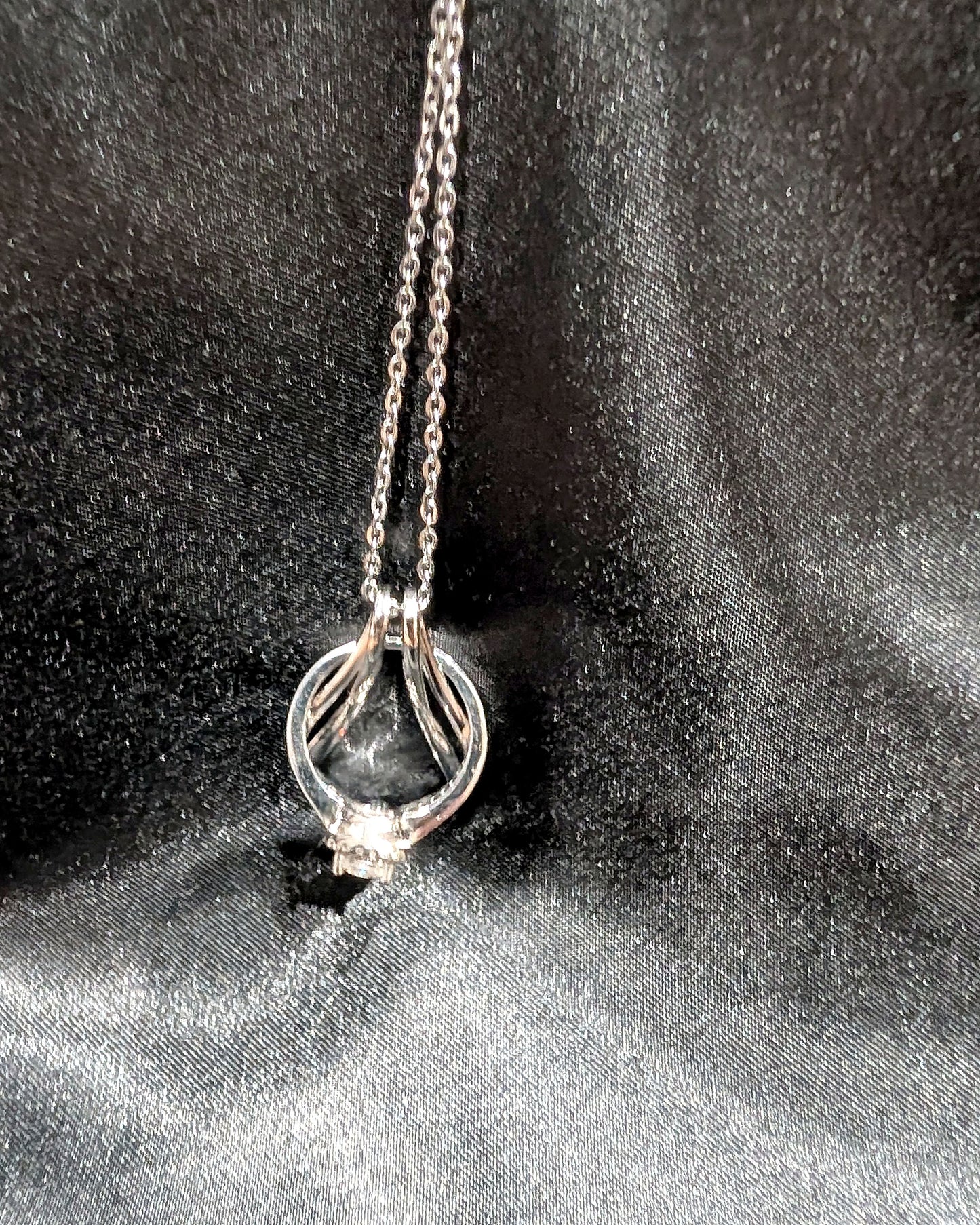 Ring Holder Necklace in silver finish holding an engagement ring